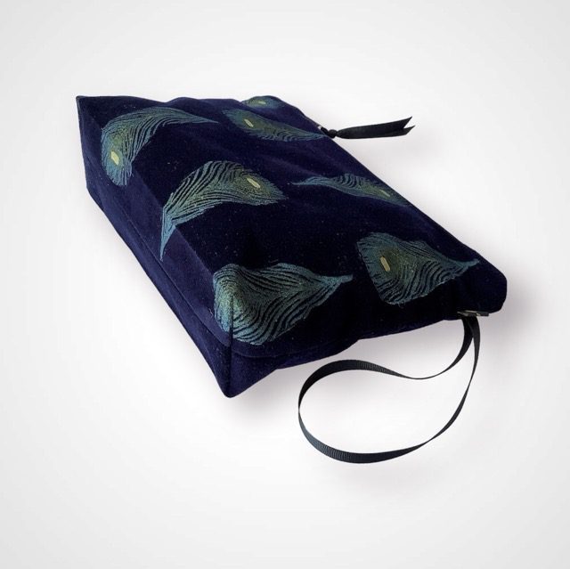 Luxury navy velvet makeup bag with blue peacock feathers print with golden shimmer