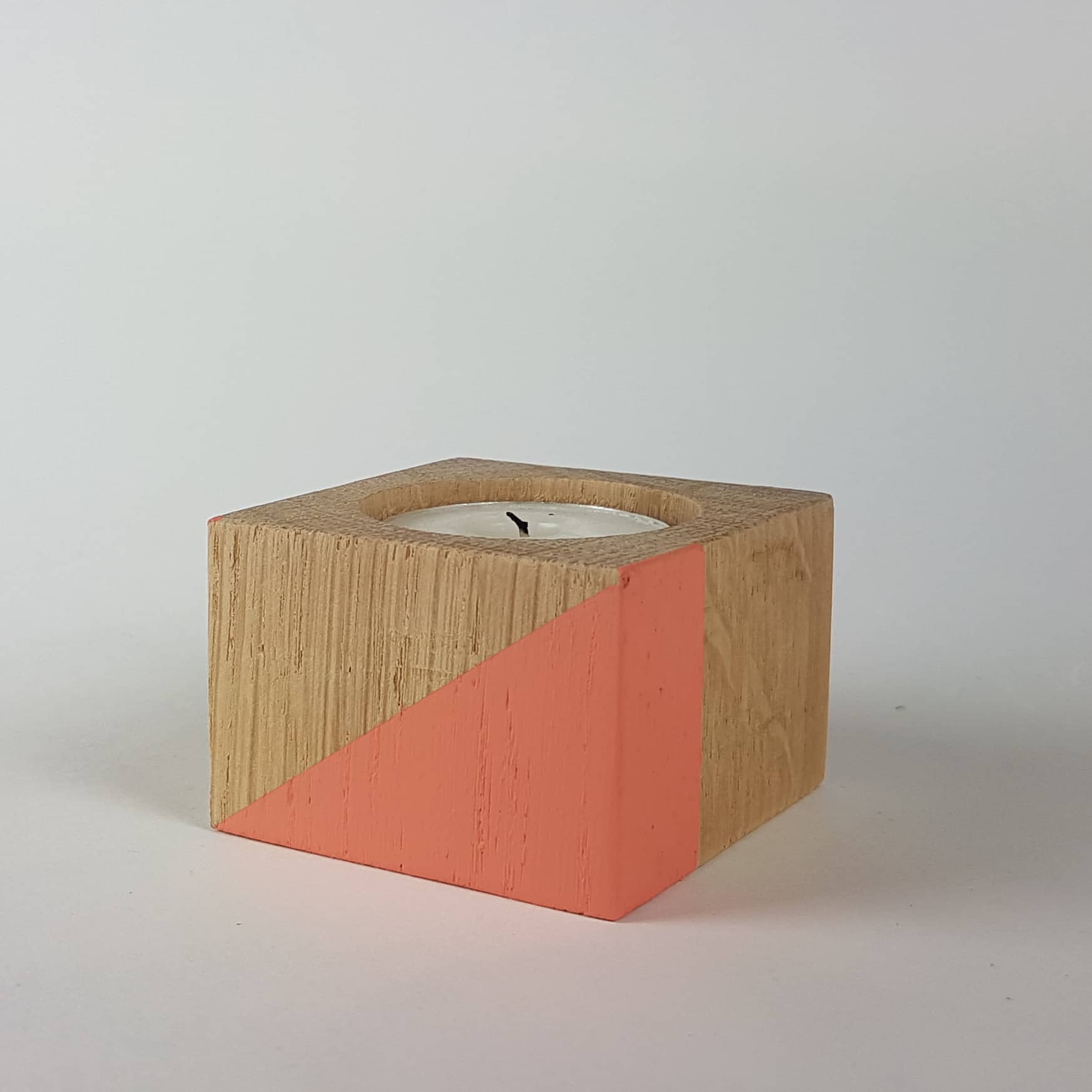 Coral coloured geometric shapes painted wooden candle holder