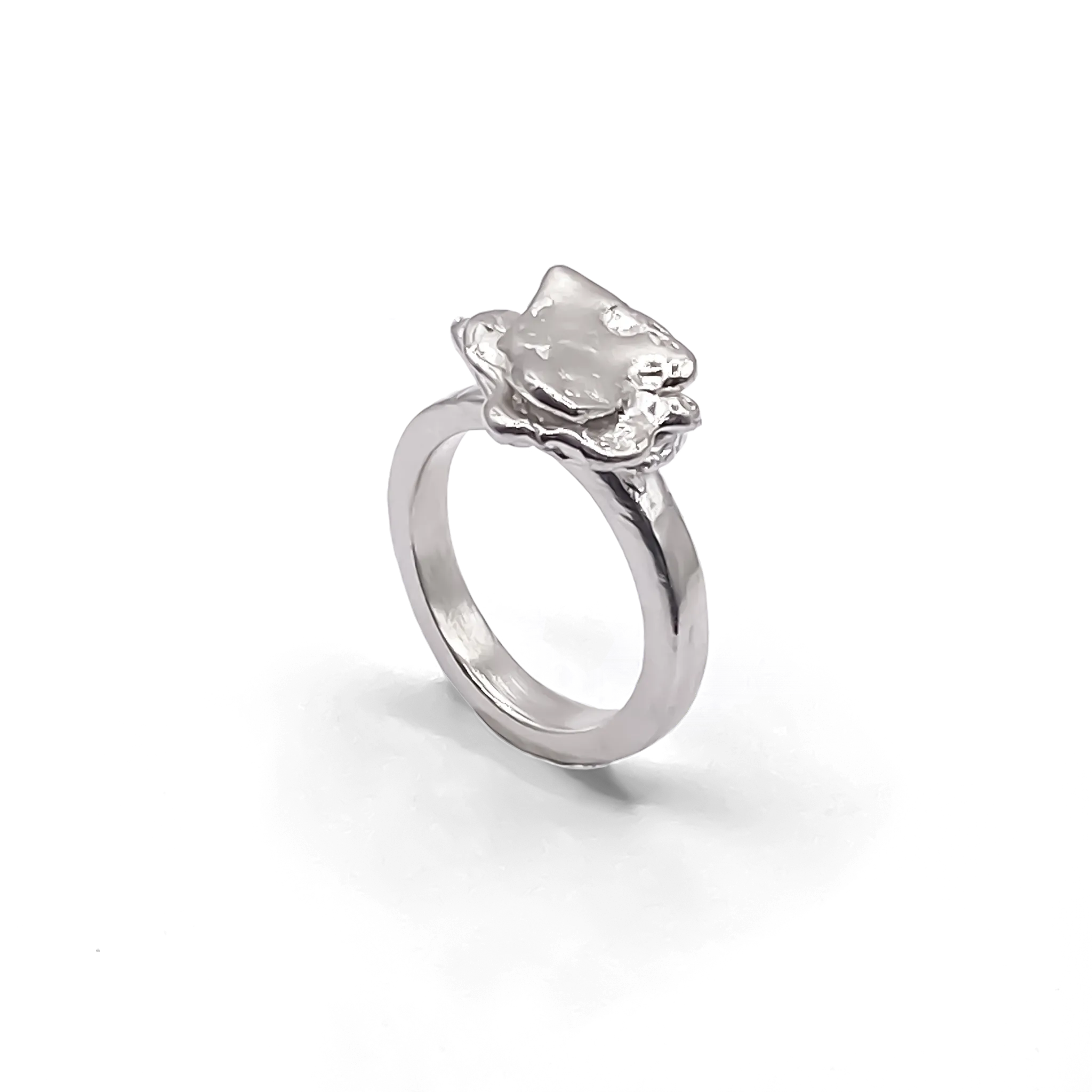 Studio shot of sterling silver flower ring with organic petal texture