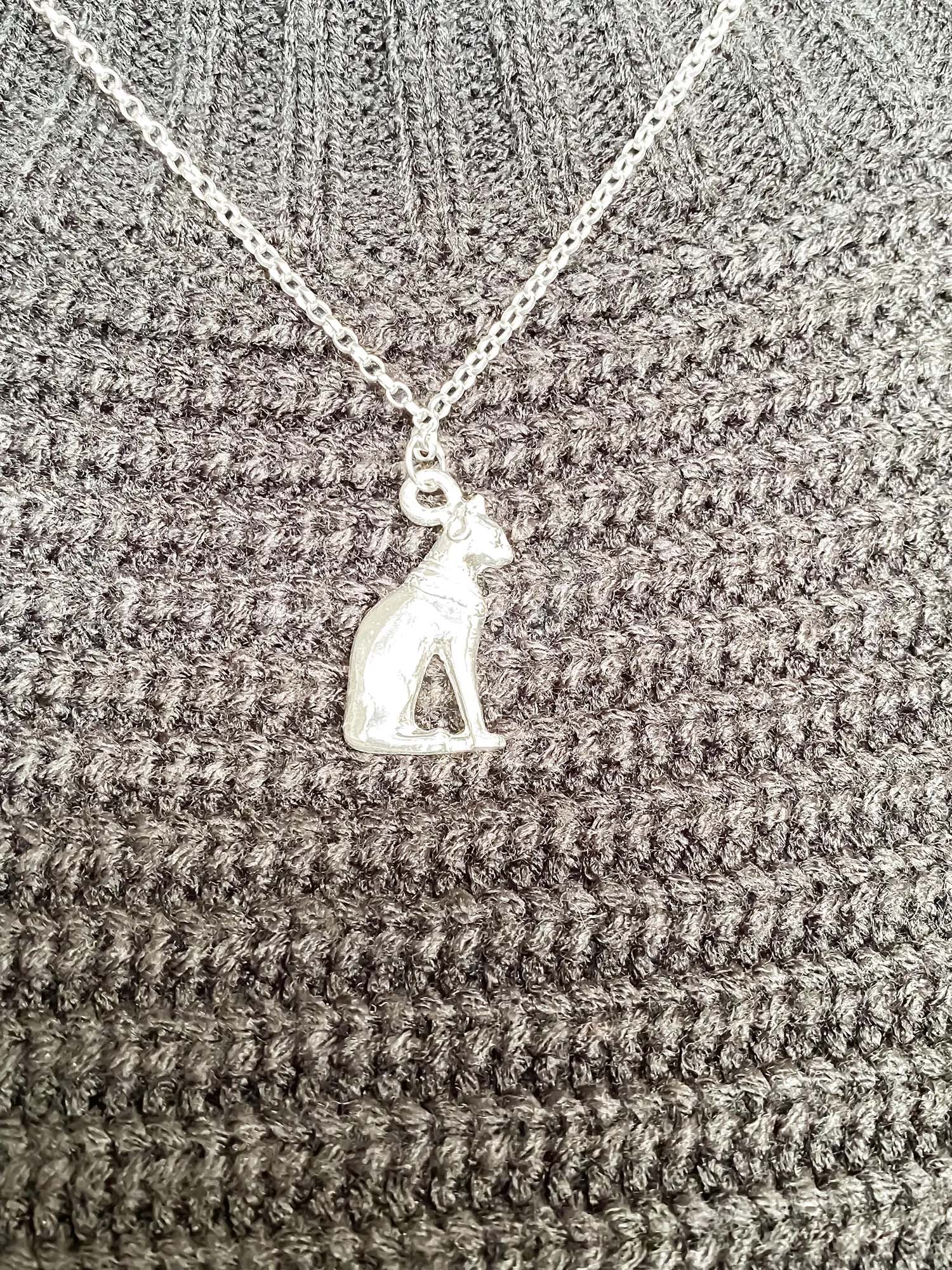 Silver Bast Cat pendant worn on black knitwear