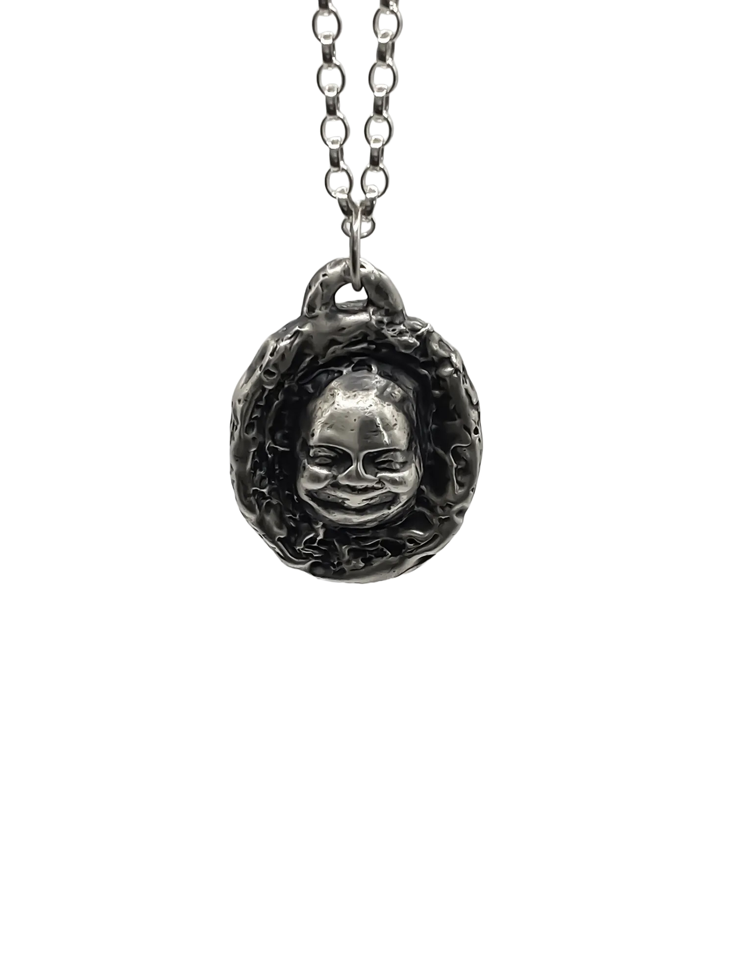 Close-up of Buddha Face Pendant in sterling silver, front view on white background