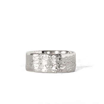 Hammered silver ring photographed on a white background, angled to show texture.