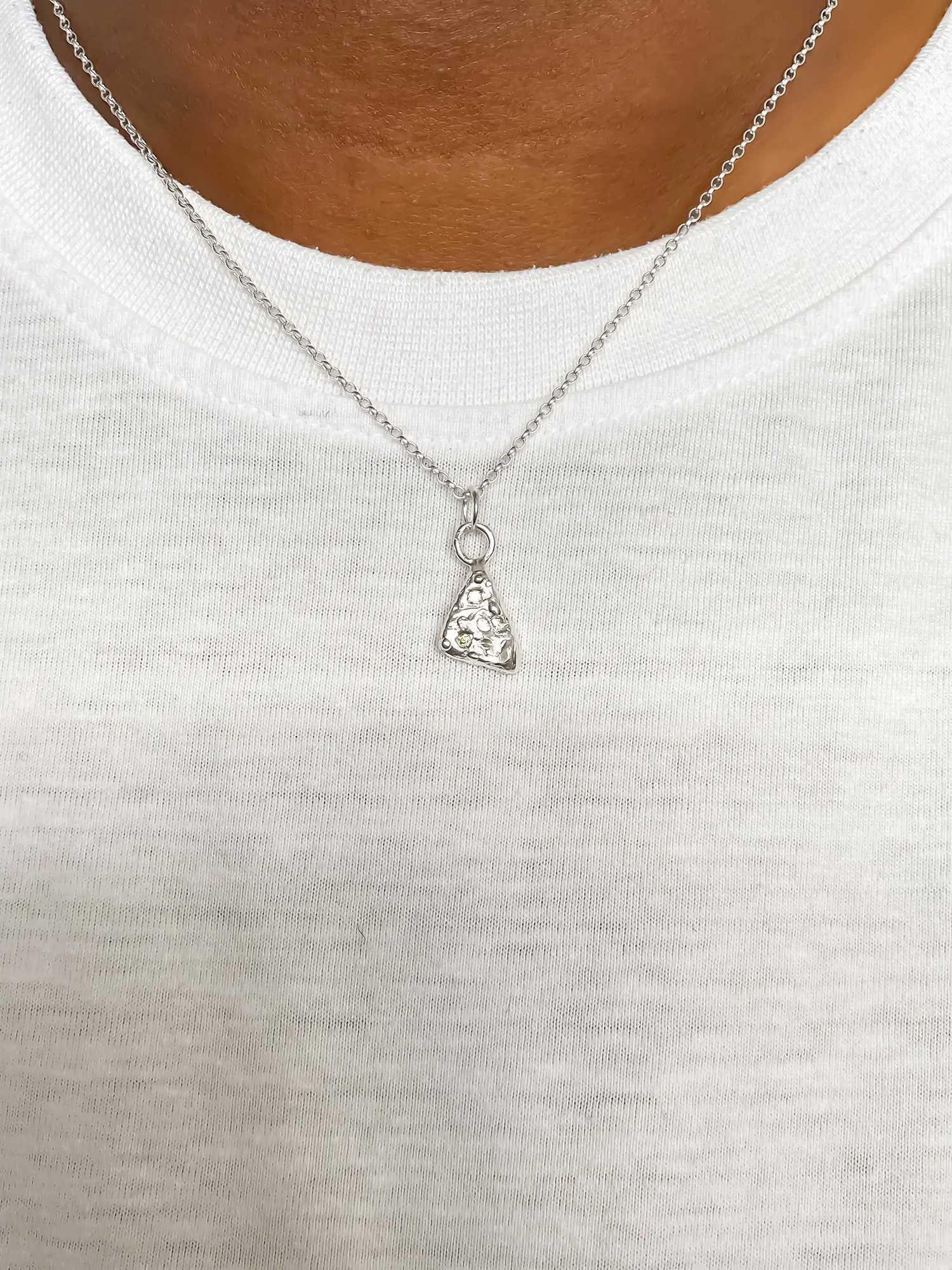 Sterling silver pendant worn with white top.