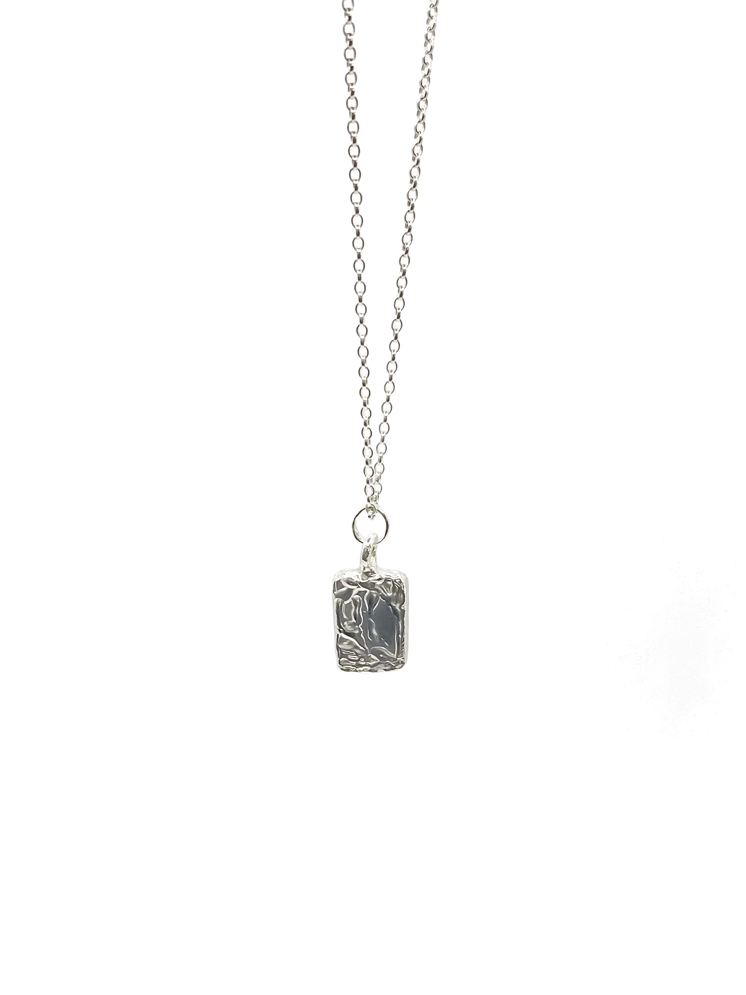 Alternative silver chain styling with rectangular pendant flat lay