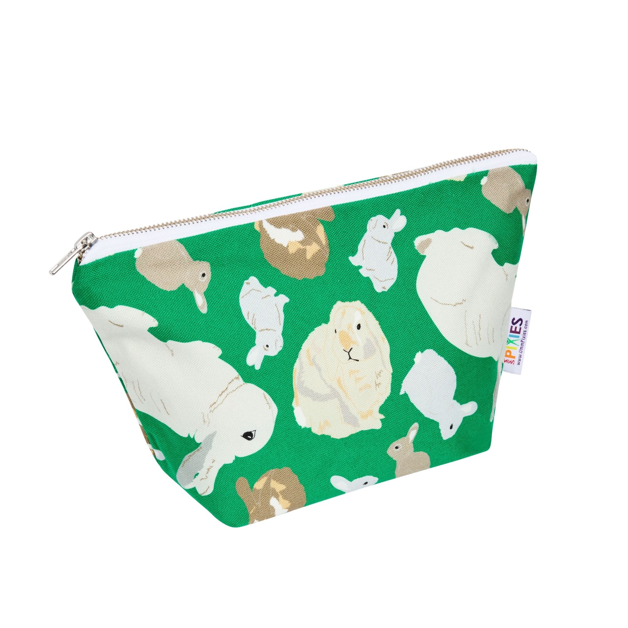 Green zipped pouch with rabbits illustrations on the outside and on the waterproof lining