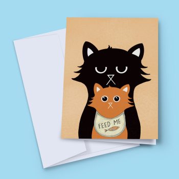 Little Paws greeting card featuring an illustrated tired black cat standing behind a wide-eyed orange kitten wearing a beige 'Feed Me' bib with a fish design, on a tan background, shown with a white envelope