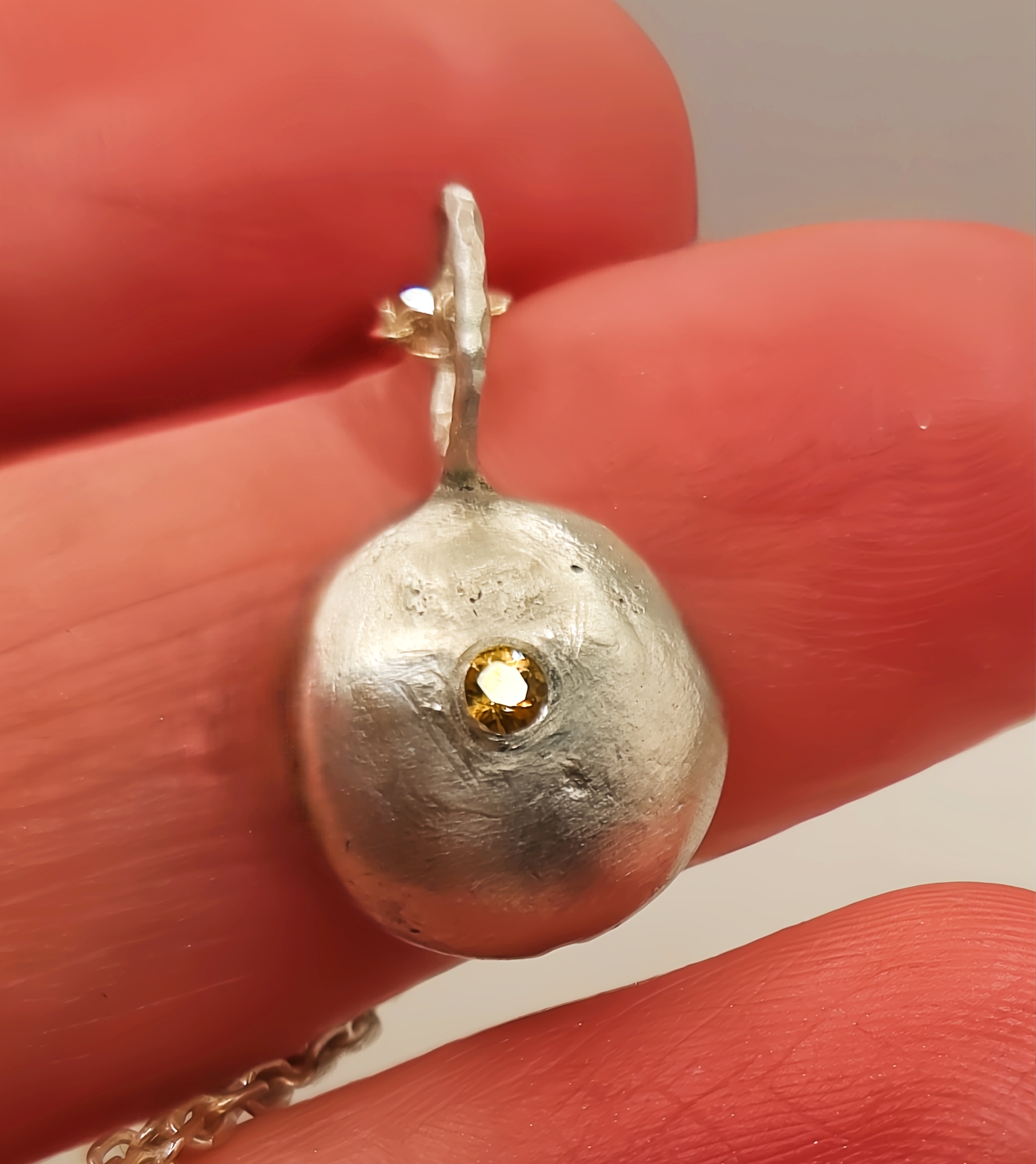 Molten Silver Pebble Pendant with Yellow Sapphire