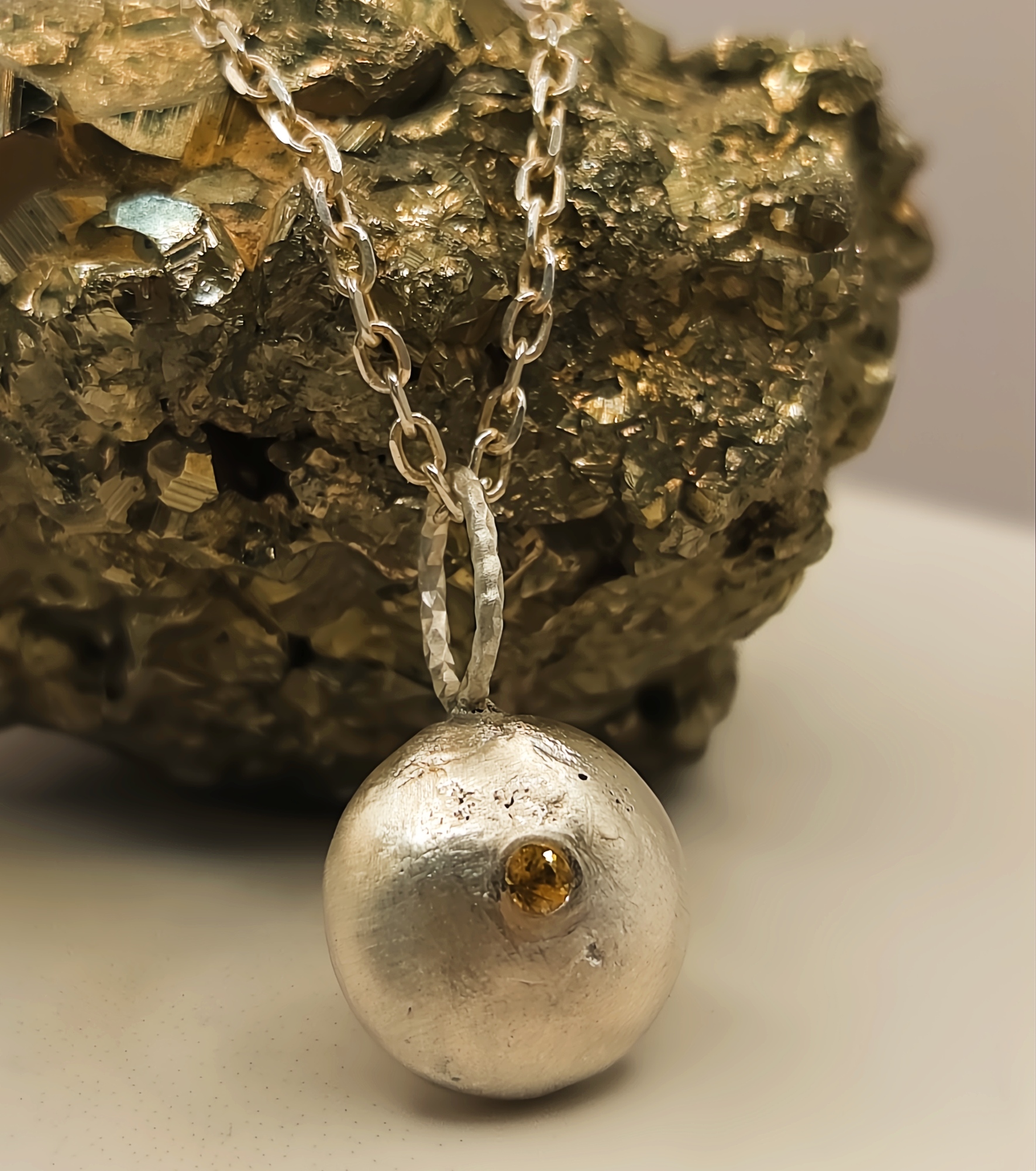 Molten Silver Pebble Pendant with Yellow Sapphire