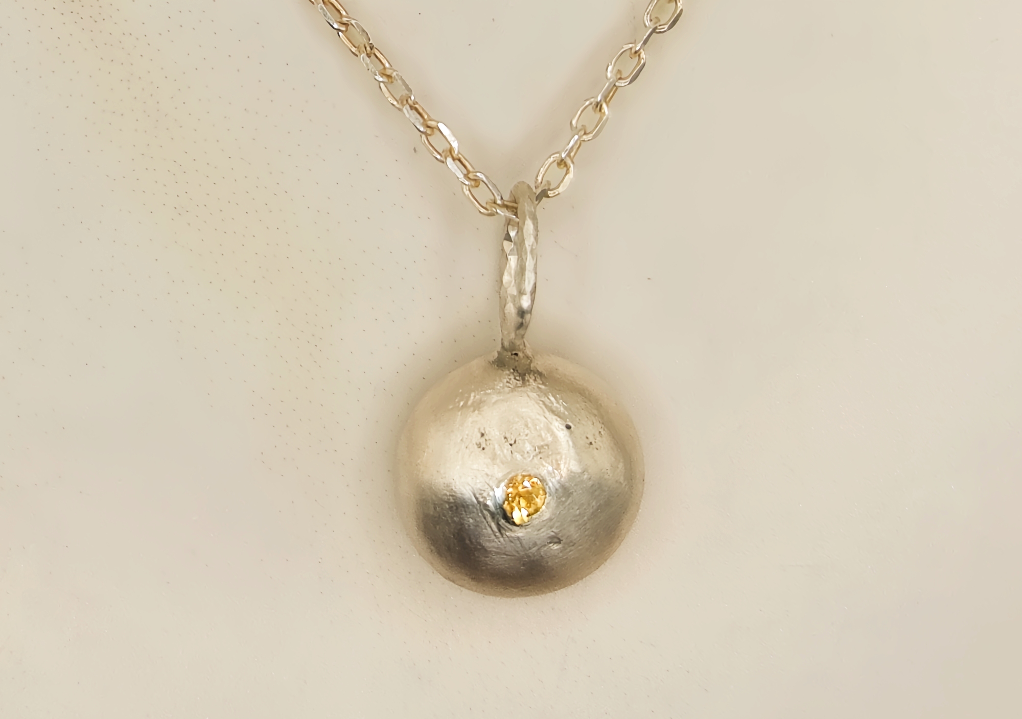 Molten Silver Pebble Pendant with Yellow Sapphire